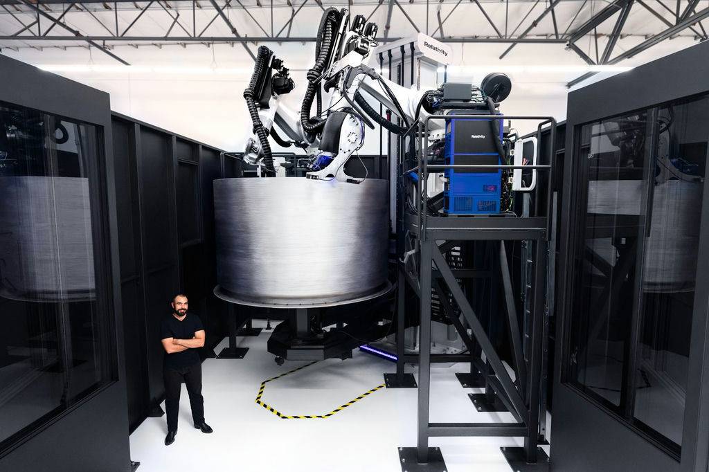 Jordan Noone, Relativity's CTO and cofounder, stands beside the second version of the Stargate 3D printer at the company's headquarters. Source: Relativity
