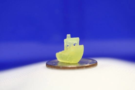 A boat figurine produced by a new 3D printing process that makes it possible to print an object within a volume of resin – like an action figure floating in the center of a block of Jell-O – rather than having to build the object layer by layer. (Image credit: Dan Congreve)