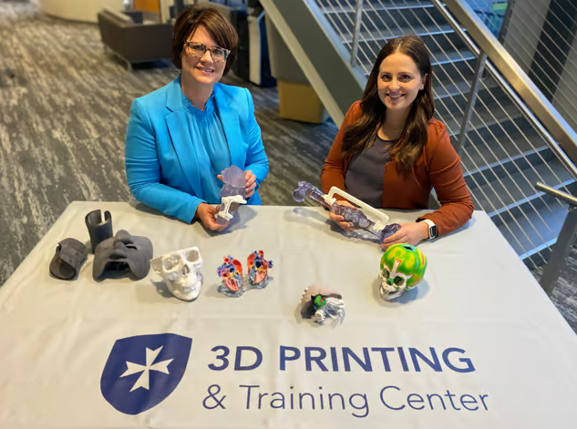 Clarkson College’s Assistant Director of Radiography/Medical Imaging and Advanced Technology Patricia (Trish) Weber (left) and 3D Printing and Training Center Administrator Blair Kauzlarich (right) showcase patient-specific boluses, surgical guides, and anatomic models 3D printed through the new partnership with 3D Systems.