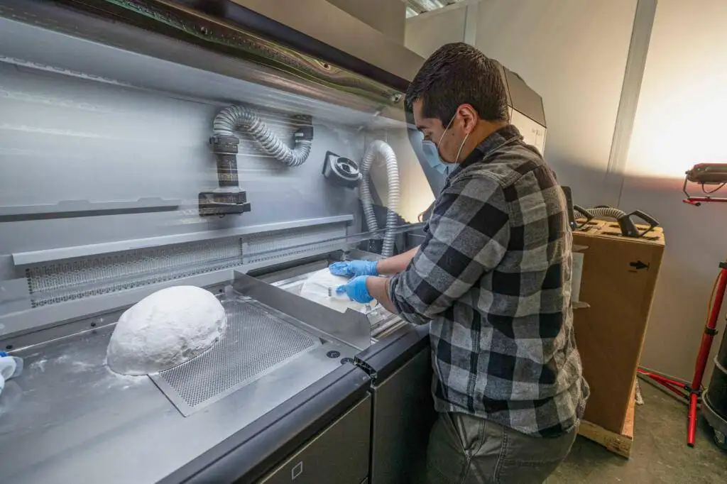 Jose Ruiz, a manufacturing engineer with the Rapid Prototyping and Fabrication Technology Division at the Naval Undersea Warfare Center Division, Keyport, in Washington manufactures personal protective equipment using additive manufacturing technology, April 22, 2020.